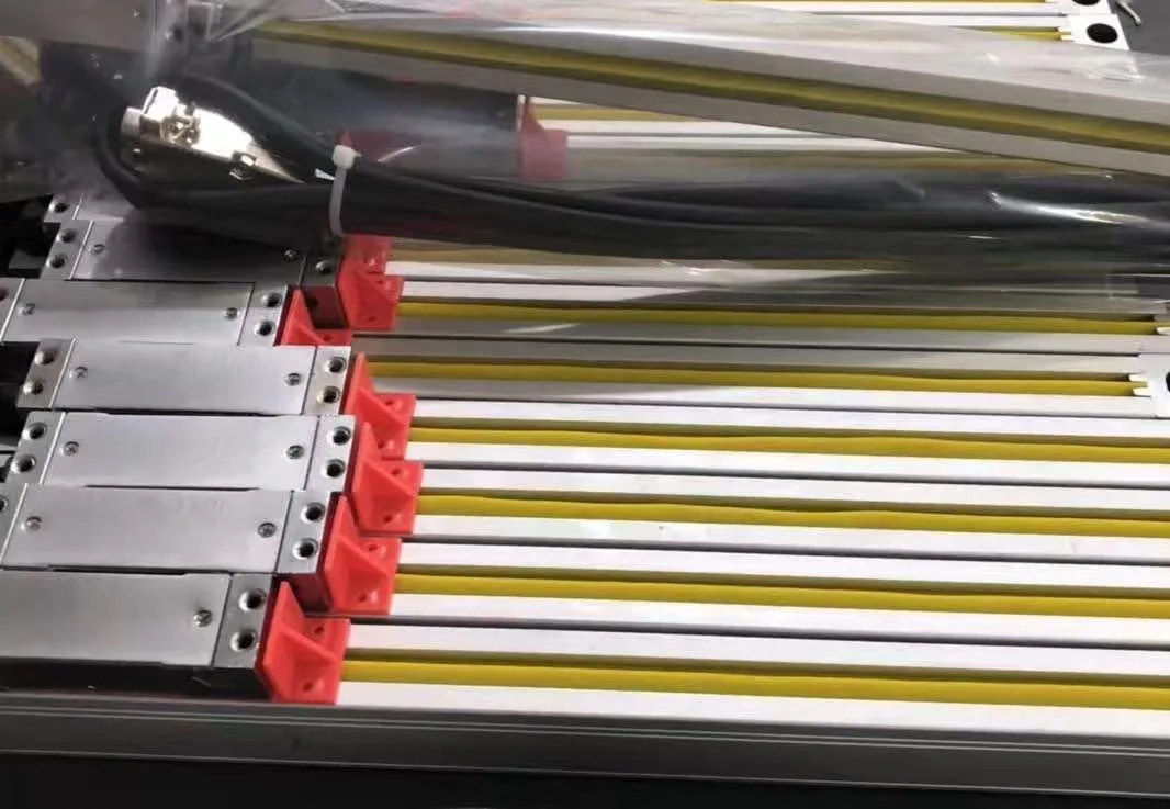 A crate of sealed linear scale rails with yellow protective tape and red end caps.