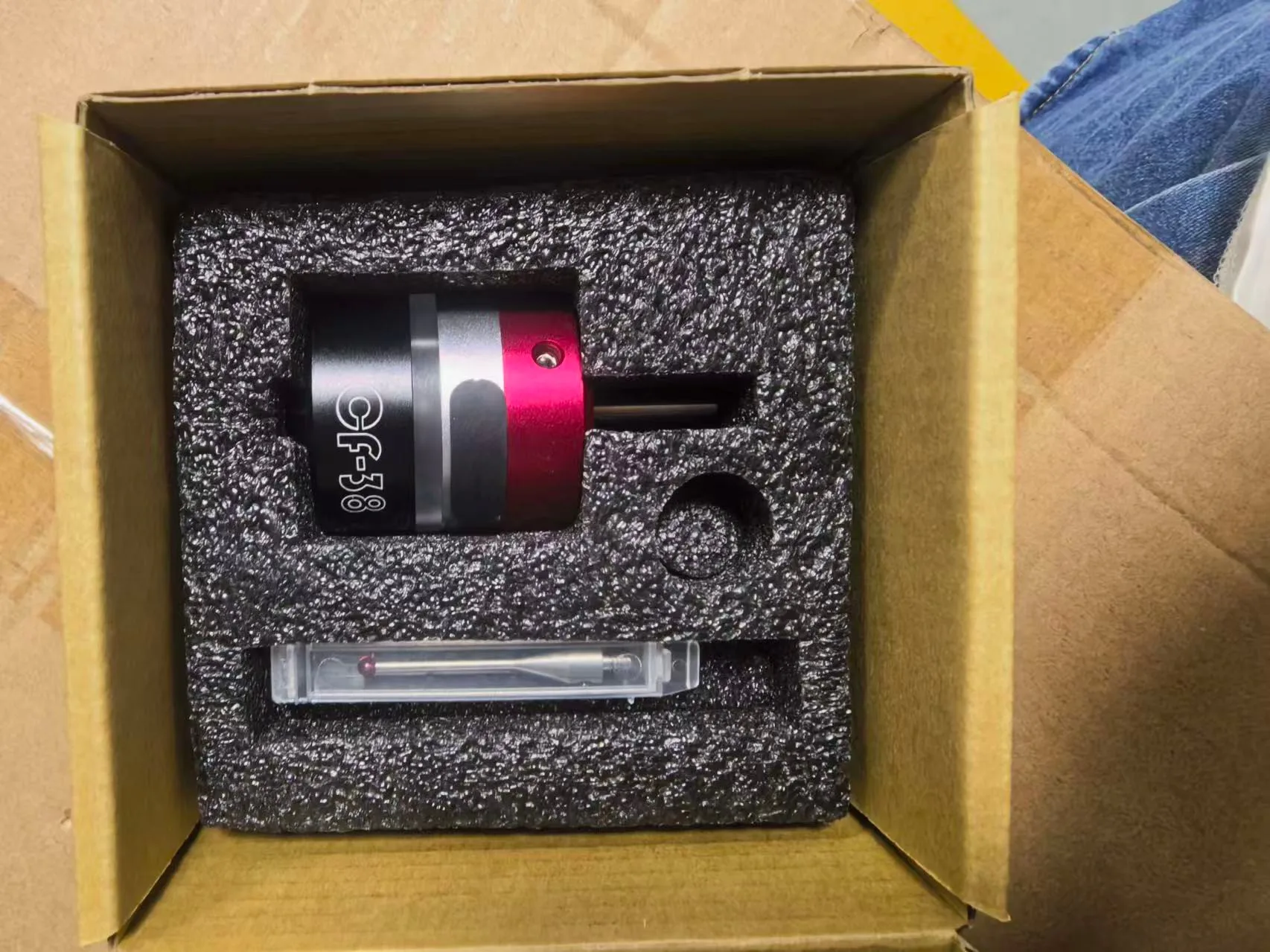 A 3D touch probe in a foam-lined carton with a spare stylus in a clear case.